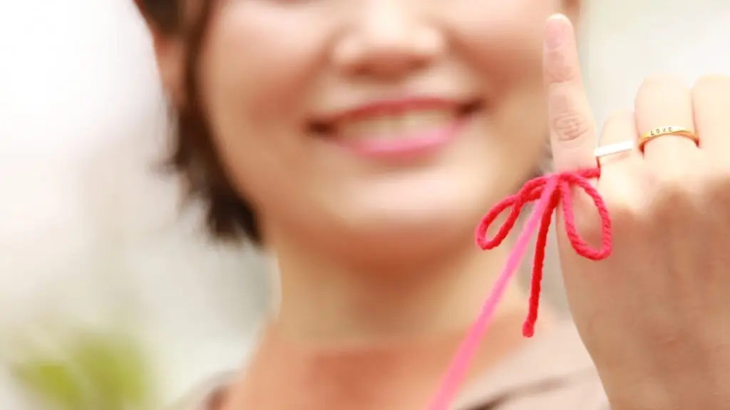 Woman with red thread around her finger