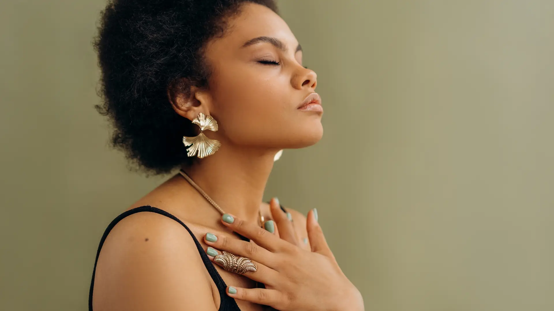 woman with hands near neck and eyes closed