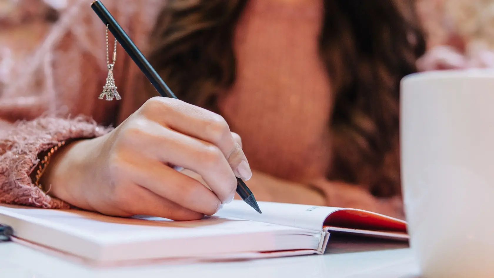 Close up of woman writing in a journal