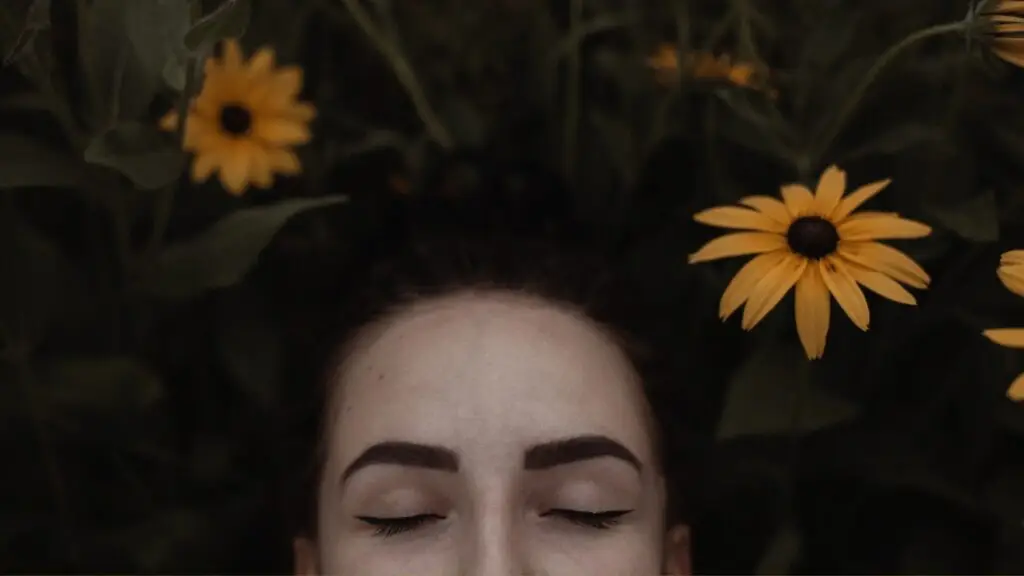 Woman laying down in field of flowers