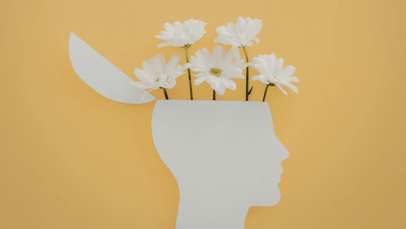 Profile of head with flowers growing from brain