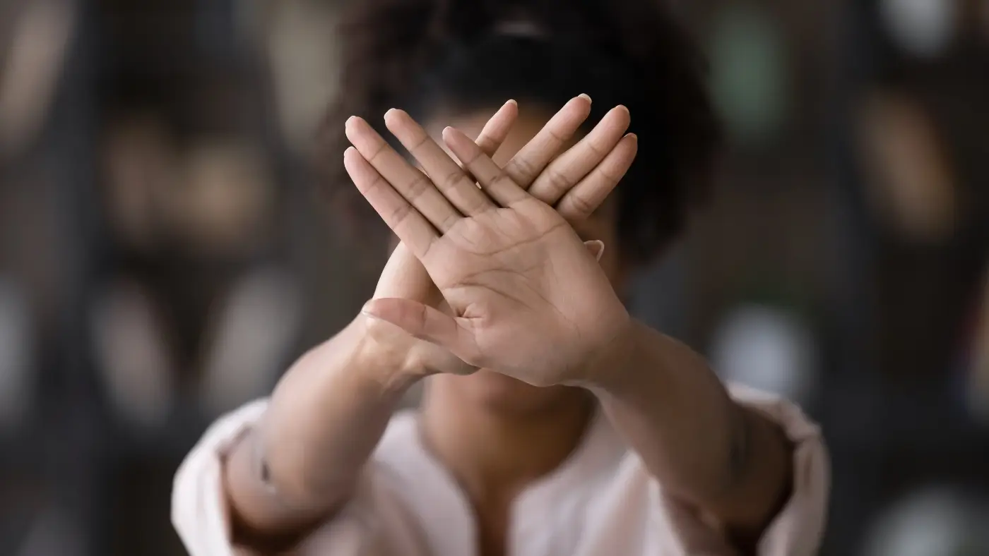woman holding hands to camera