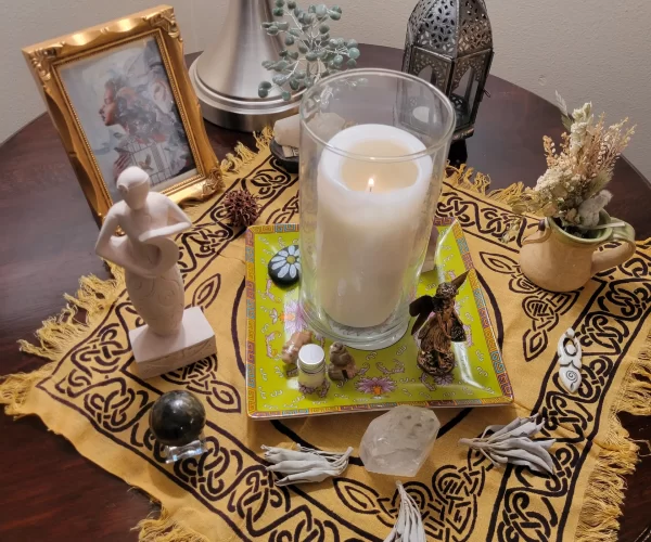 table set up featuring candles and statues